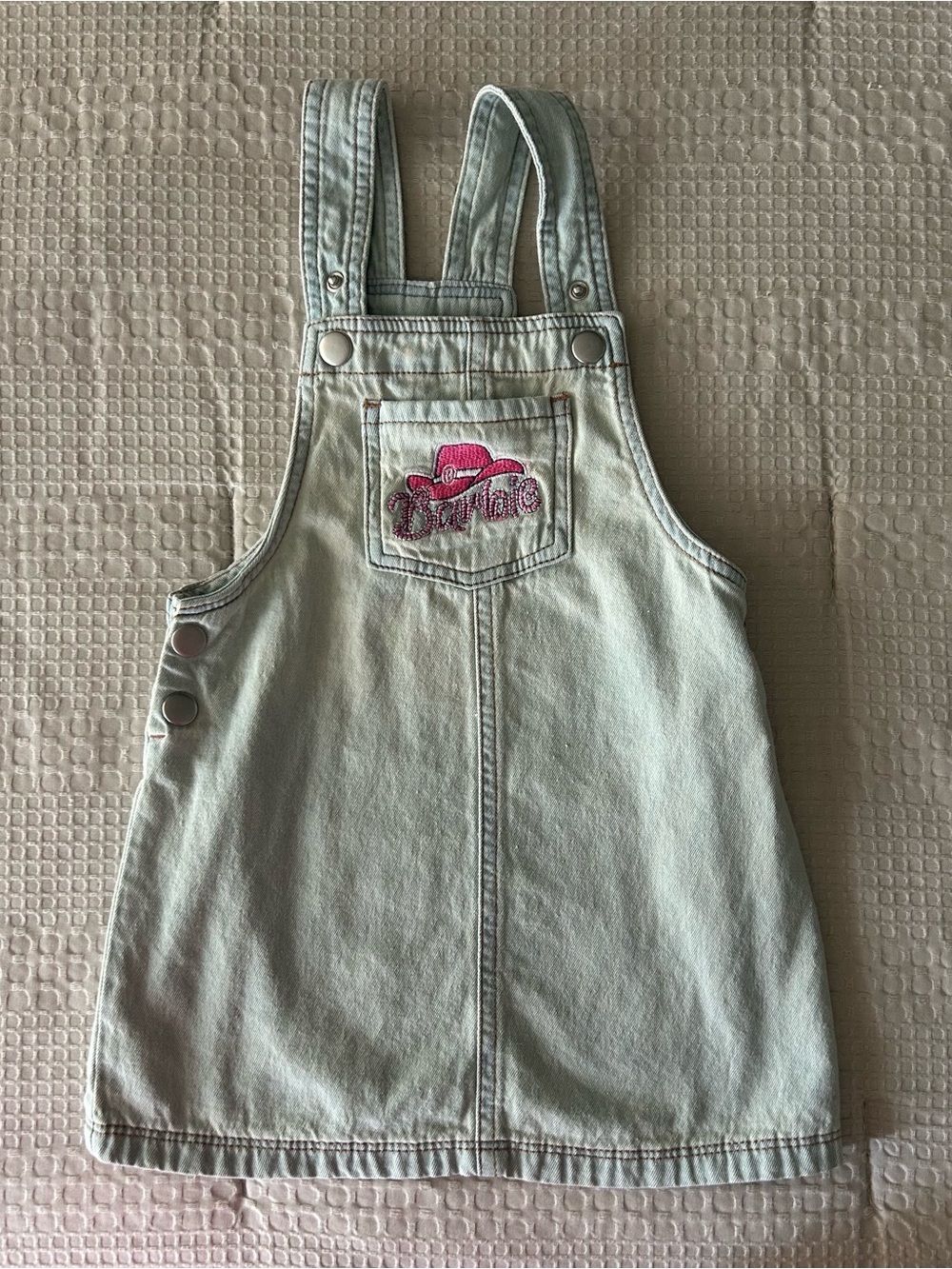 Barbie light wash denim toddler skirtall featuring a pink embroidered cowboy hat